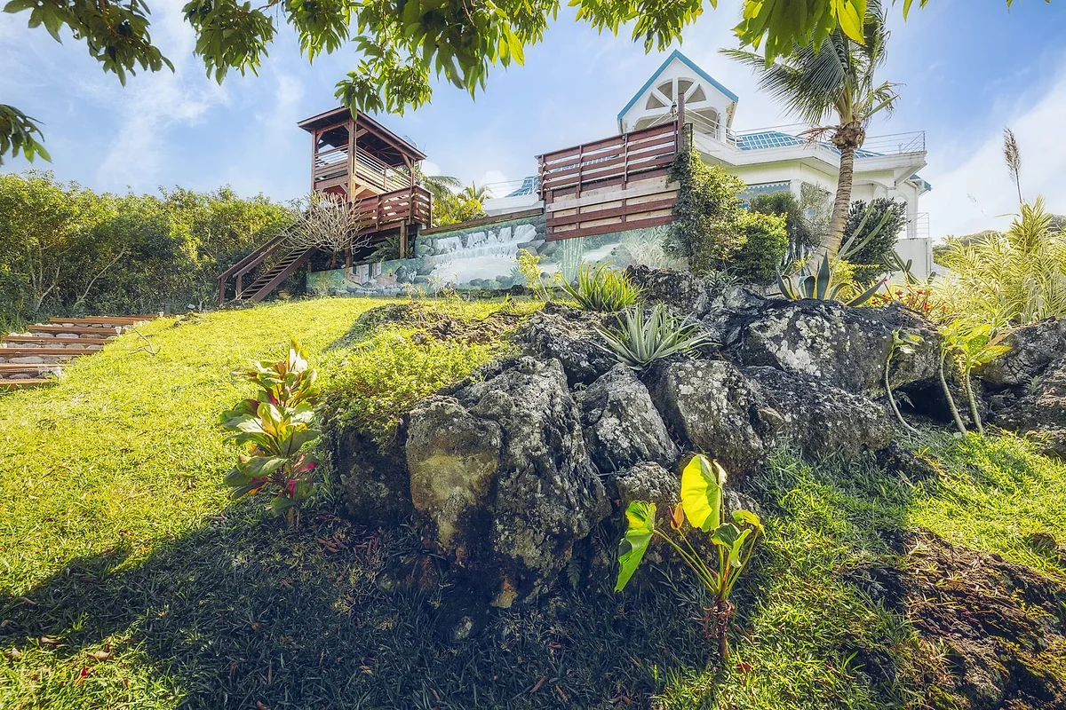 Le jardin de La Plantation, ses rochers de lave et la maison en haut de la pente